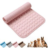 A pink rolled-out cooling mat with a raised bubble texture, shown on a white background with small thumbnails of other color options and several pets (a cat, dog, and two smaller dogs) at the bottom right.