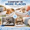 A promotional collage showing a quilted pet cooling mat in four home settings: a golden retriever on a mat in a living room, a small dog on a sofa, a gray dog in a crate, and a tabby cat on a bedside mat. Large text reads 'COMFORT IN MORE PLACES' with lifestyle room scenes and labels for Living Room, Sofa, Crate, and Bedside.