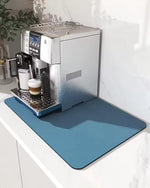 Espresso machine on a counter with a blue mat underneath