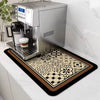 Espresso machine on a decorative mat with a coffee cup on a kitchen counter.