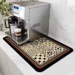 Espresso machine on a decorative mat with a coffee cup on a kitchen counter.
